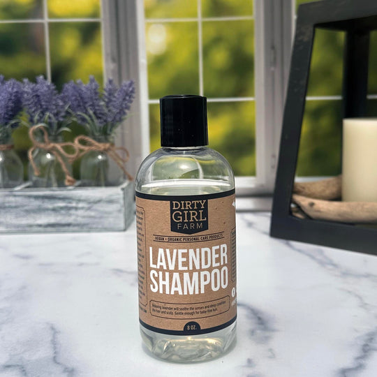 Dirty Girl Farm Lavender Shampoo on a counter with lavender and candle